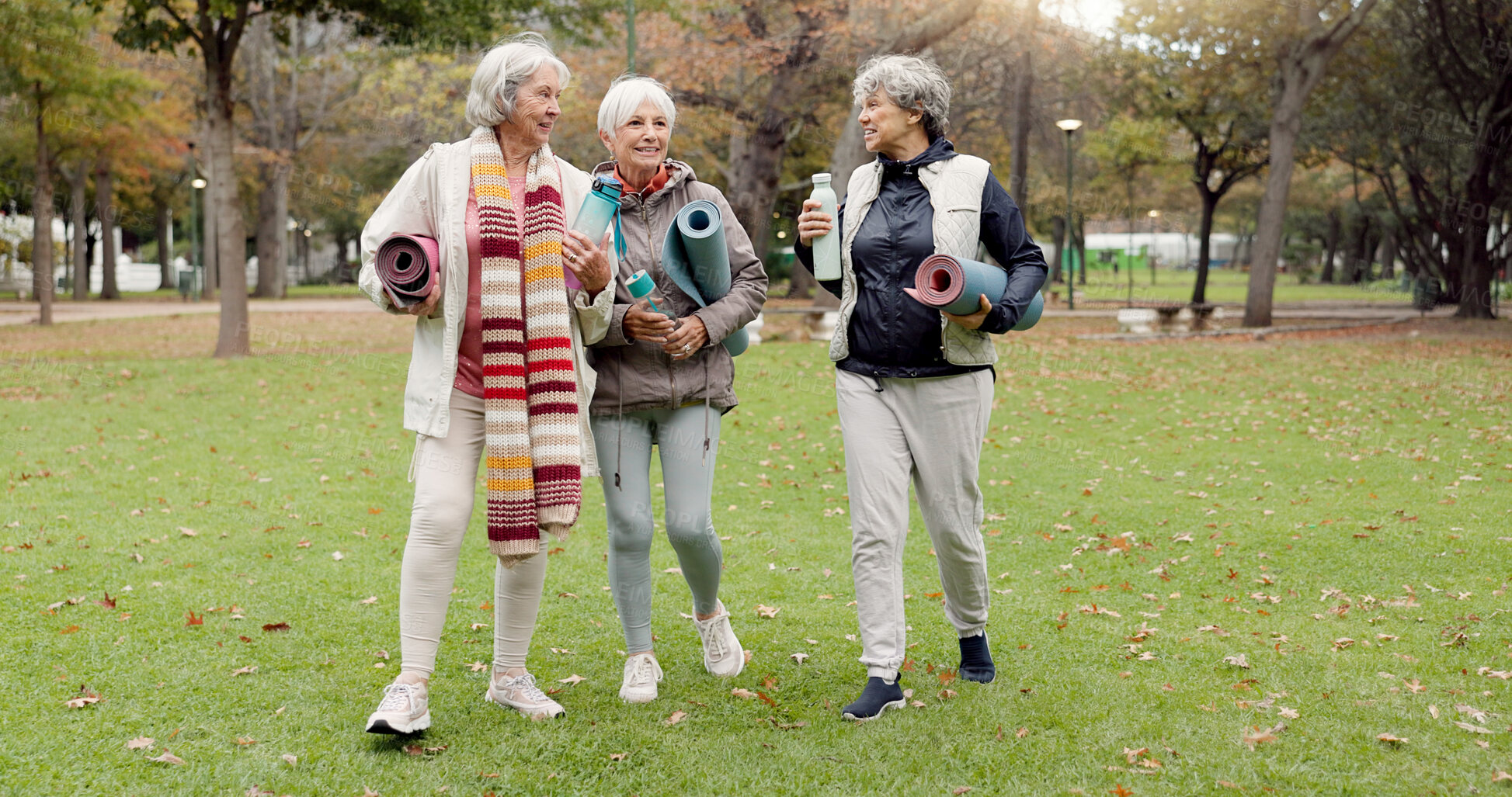 Buy stock photo Senior friends, walking and talking with yoga mats in the park to relax in nature with elderly women in retirement. People, happy conversation and healthy outdoor exercise or pilates in winter