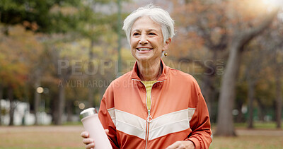 Fitness, senior woman and walking at park for healthy body, wellness or exercise with bottle. Smile, workout and elderly athlete outdoor, nature or garden for cardio, sport and travel for retirement