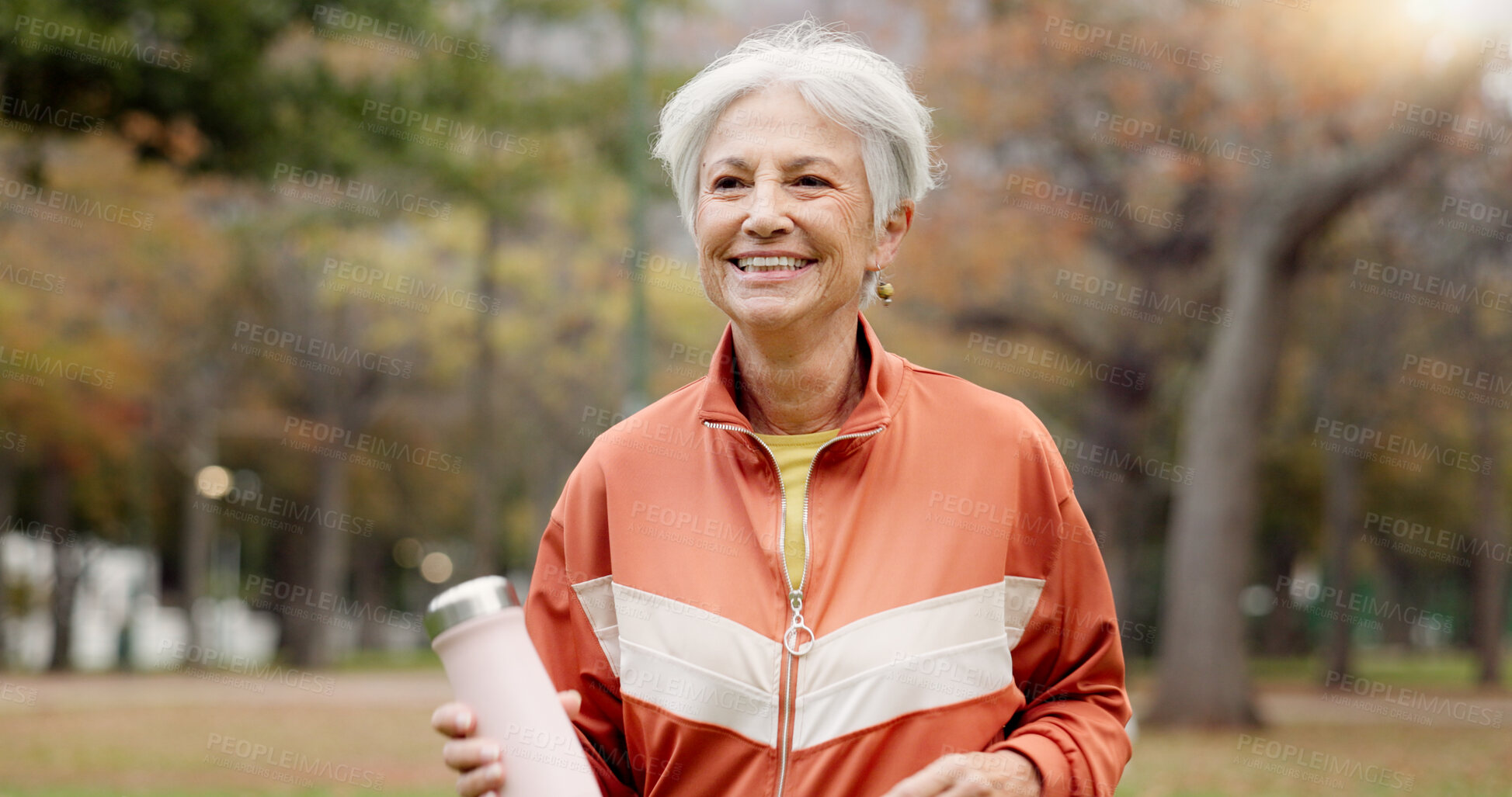 Buy stock photo Fitness, senior woman and walking at park for healthy body, wellness or exercise with bottle. Smile, workout and elderly athlete outdoor, nature or garden for cardio, sport and travel for retirement