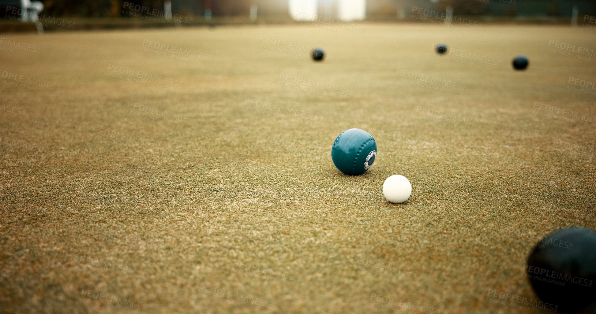 Buy stock photo Green, balls and game of lawn bowling on grass, field or pitch in match or competition of outdoor bowls. Ball, moving and sport tournament at bowlers club, league or championship games on the ground