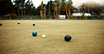 Green, lawn bowling and balls on grass, field or pitch in a match, game or competition of outdoor bowls. Ball, sport and tournament at a bowlers club, league or championship games on the ground