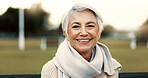 Face, elderly woman and happy on park bench on vacation, holiday or travel in winter. Portrait, smile and senior person in nature, outdoor or garden for freedom to relax for retirement in Australia