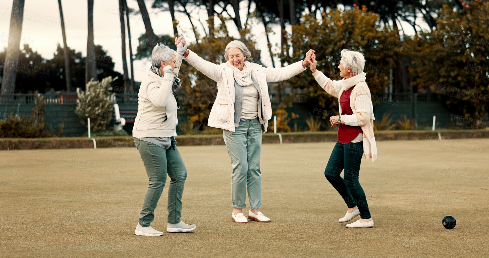 Buy stock photo Senior women, celebration and park for sport, lawn bowling and happy for fitness, goal or applause in nature. Teamwork, elderly lady friends and metal ball for games, contest or win together on grass