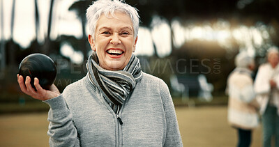 Senior woman, lawn bowling and park with face for sport, fitness or game for competition, health or fun. Elderly lady, metal ball and grass for contest, excited smile or workout in outdoor portrait