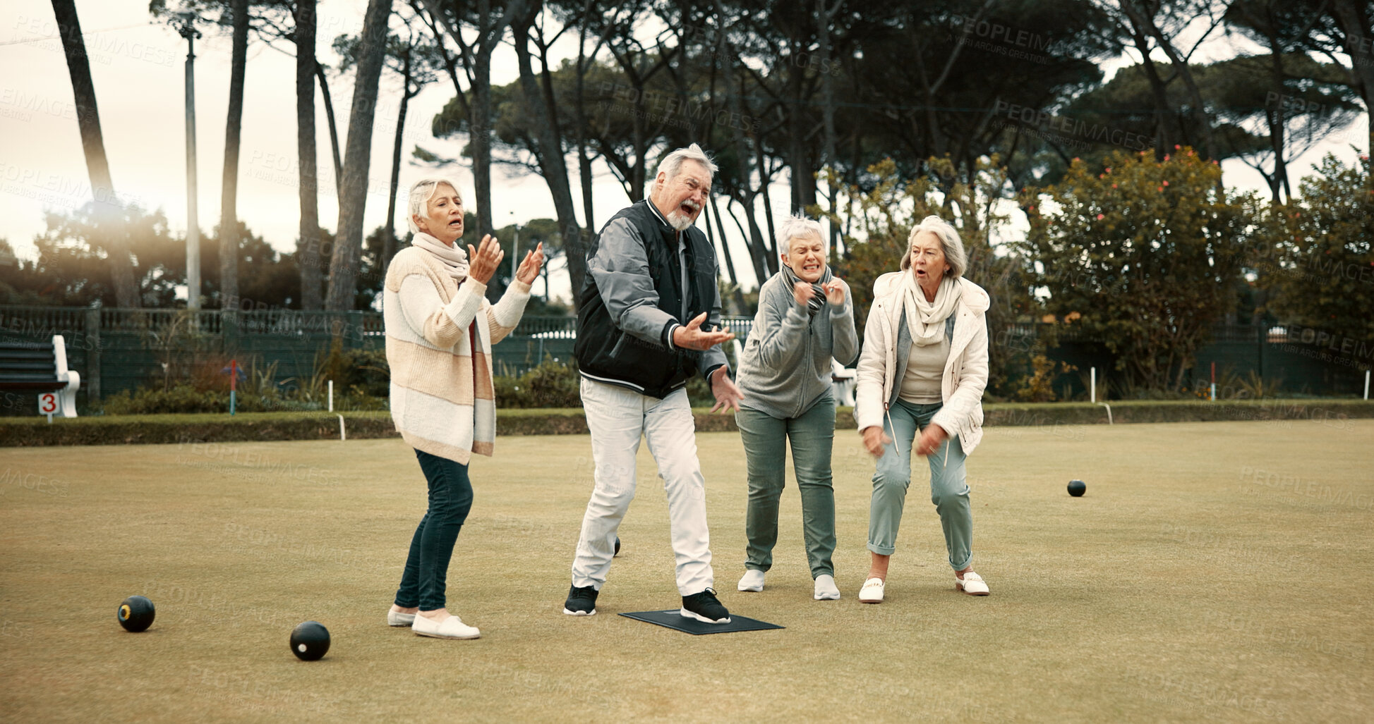 Buy stock photo Senior man, team and bowling on grass with miss, fail or support for fitness, sport or game in retirement. Teamwork, group and elderly women with metal ball, exercise or kindness for training on lawn