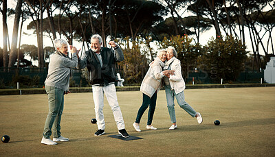 Bowls, high five and celebration with senior friends outdoor, cheering together during a game. Motivation, support or applause and a group of elderly people cheering while having fun with a hobby