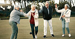 Bowls, celebration and hugging with senior friends outdoor, cheering together during a game. Motivation, support or applause and a group of elderly people clapping while having fun with a hobby