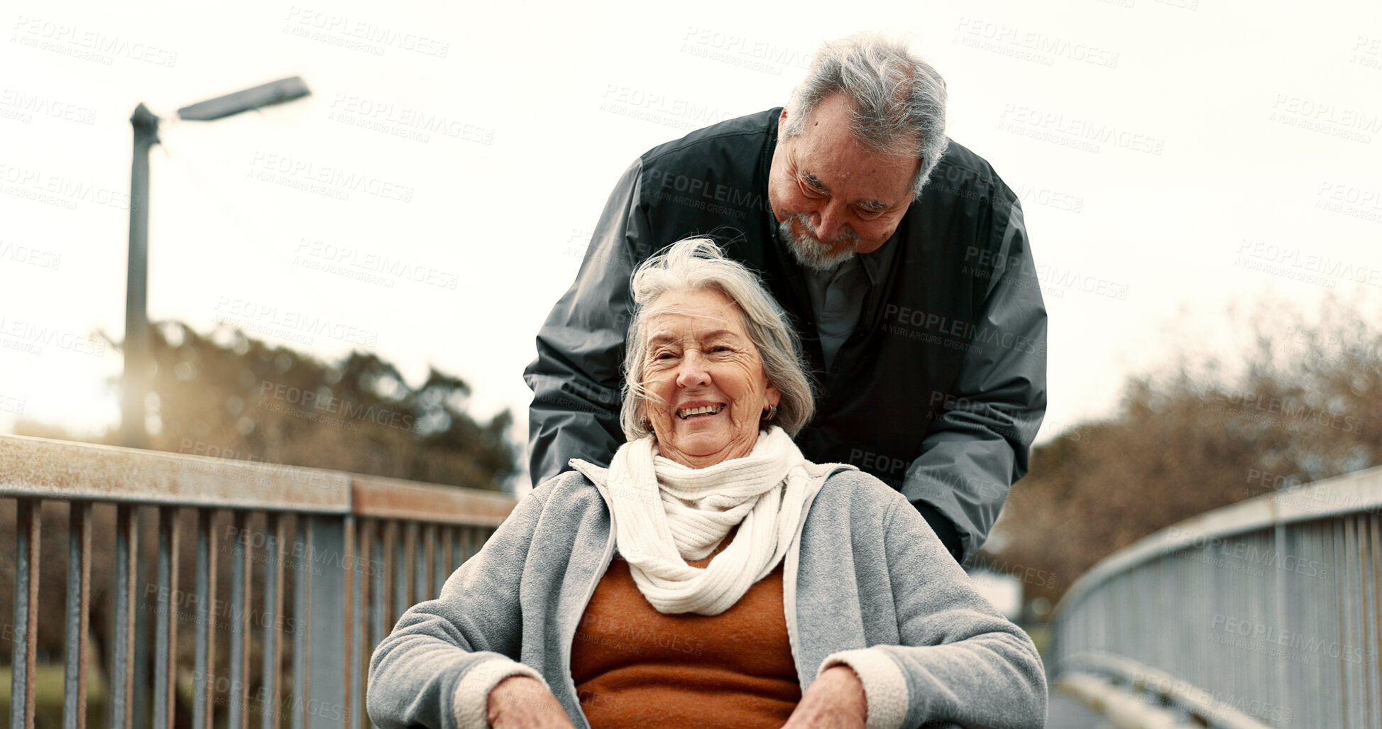 Buy stock photo Senior couple, nature and in a wheelchair on a walk for happiness, retirement date or love. Smile, talking and an elderly man and woman with a disability and in a park to relax together in marriage
