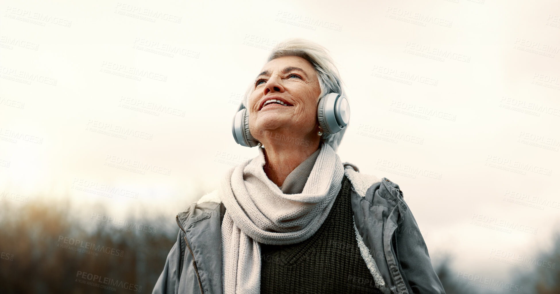 Buy stock photo Headphones, music and senior woman in nature for wellness, mental health and happy outdoor experience. Travel, listening and streaming service or podcast of elderly person thinking in park and winter