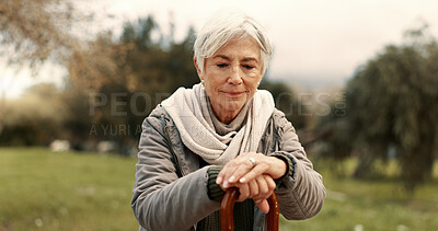 Nature, cane and senior woman in a park walking for fresh air, exercise or wellness with peace. Calm, smile and elderly female person in retirement with a stick for support at an outdoor garden.