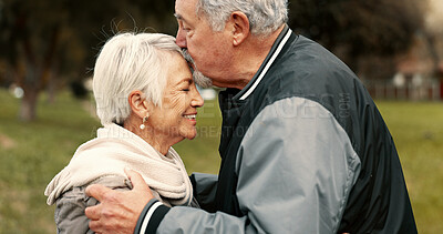 Love, smile and kiss with a senior couple hugging outdoor in a park together for a romantic date during retirement. Happy, support and an elderly man and woman bonding in a garden for romance
