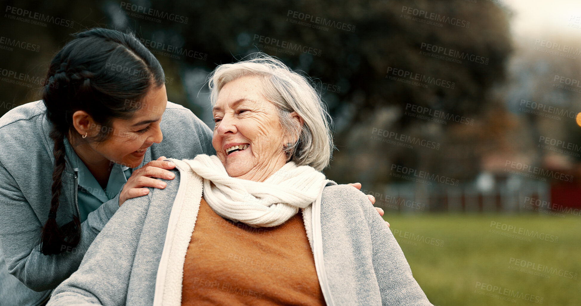 Buy stock photo Caregiver helping woman with disability in park for support, trust and care in retirement. Nurse talking to happy senior patient in wheelchair for rehabilitation, therapy and conversation in garden