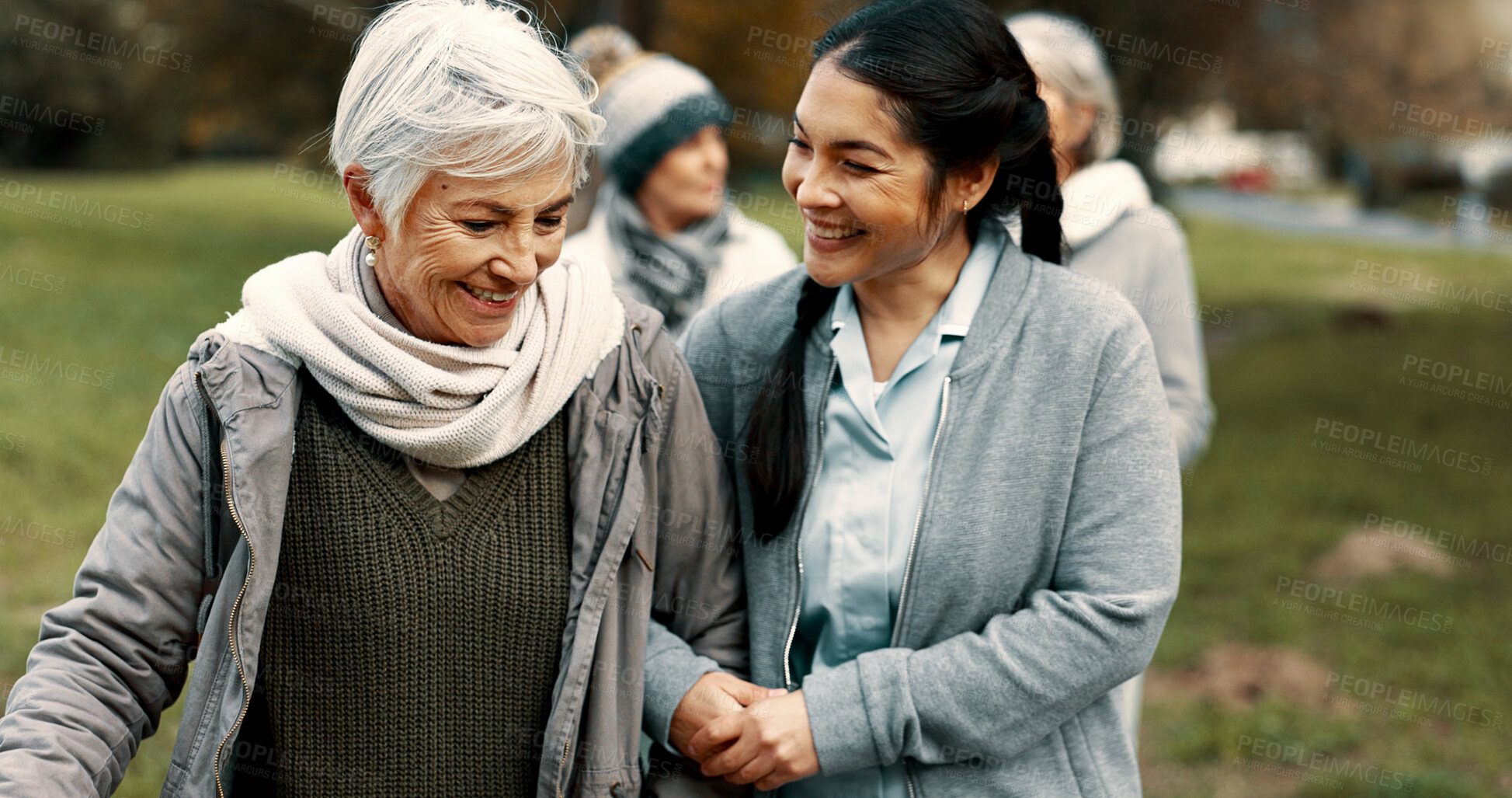 Buy stock photo Happy, walking and a woman and caregiver in nature for talking, support and relax in the morning. Help, together and a young carer speaking to a senior patient in a park or garden for bonding
