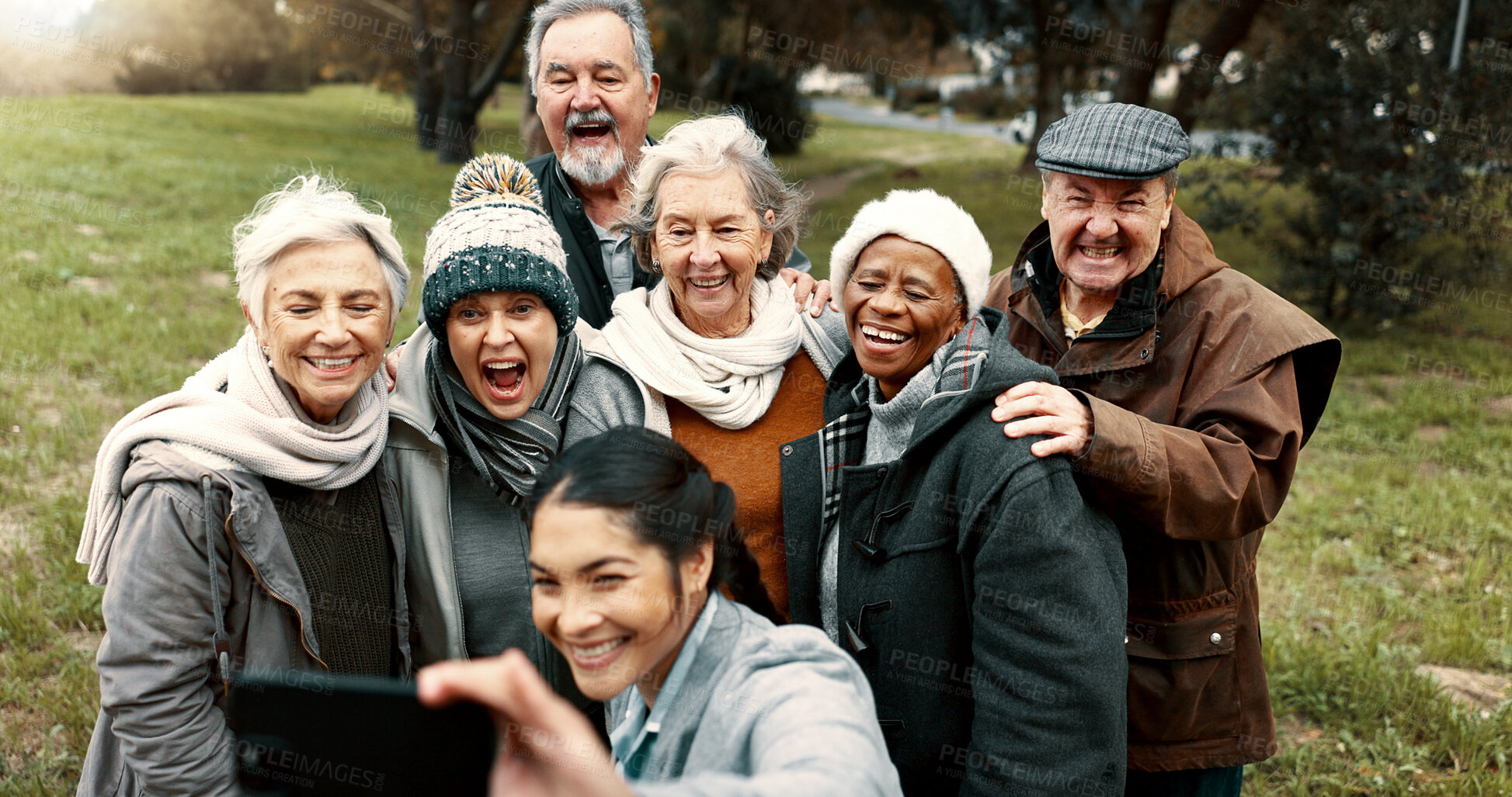 Buy stock photo Nature, selfie and senior friends with woman while walking in outdoor garden for fresh air. Diversity, happy and group of elderly people in retirement taking picture with young female person in park.