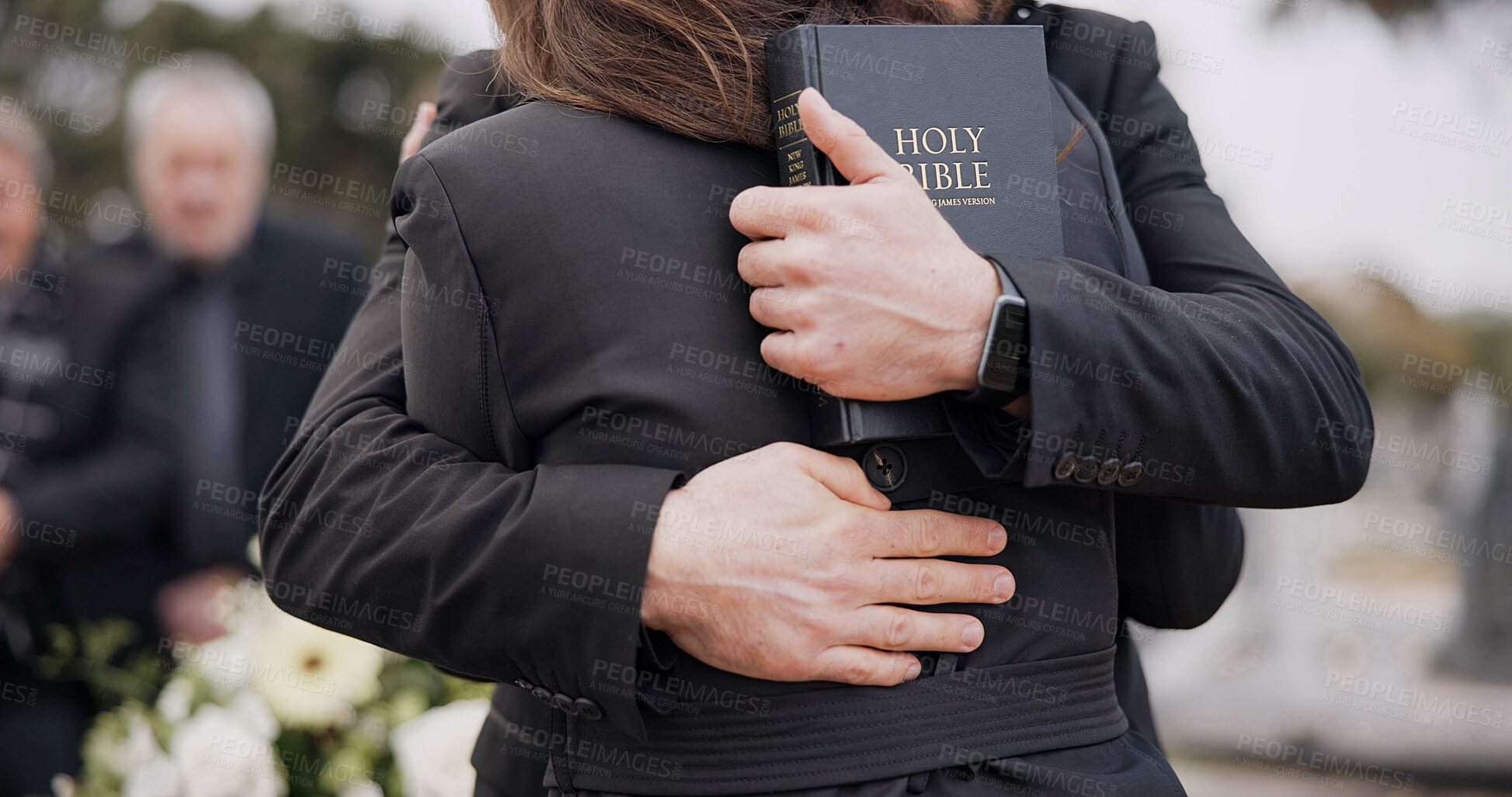 Buy stock photo Funeral, graveyard and people hug for comfort, empathy and support at memorial service in cemetery. Depression, grief and sad man and woman for goodbye, mourning and burial for death with bible