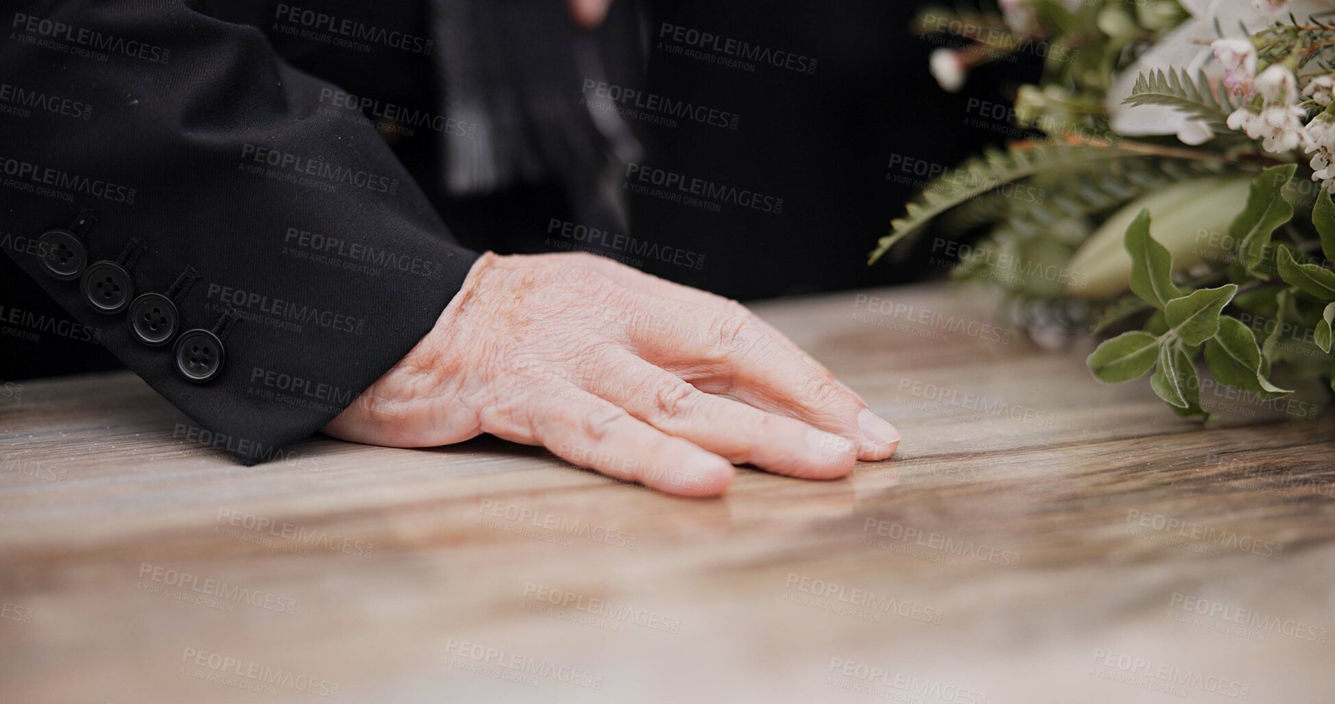 Buy stock photo Death, funeral and hand on coffin in mourning, family at service in graveyard or church for respect. Flowers, loss and people at wood casket in cemetery with memory, grief and sadness at grave burial