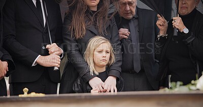 Buy stock photo Loss, grief and people at funeral with umbrella, flowers and coffin, family with sad child at service in graveyard. Roses, death and group in rain at casket in cemetery with kid at grave for burial.