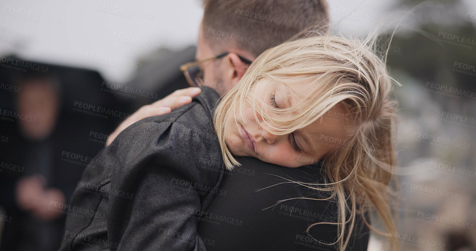 Buy stock photo Sad, death and a daughter with her father at a funeral for grief or mourning loss together outdoor. Family, empathy and a man holding his girl child at a memorial service or ceremony for condolences