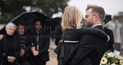 Sad, hug and a father and child at a grave for a funeral and mourning with a group of people. Holding, young and a dad with care and love for a girl kid at a cemetery burial and grieving together