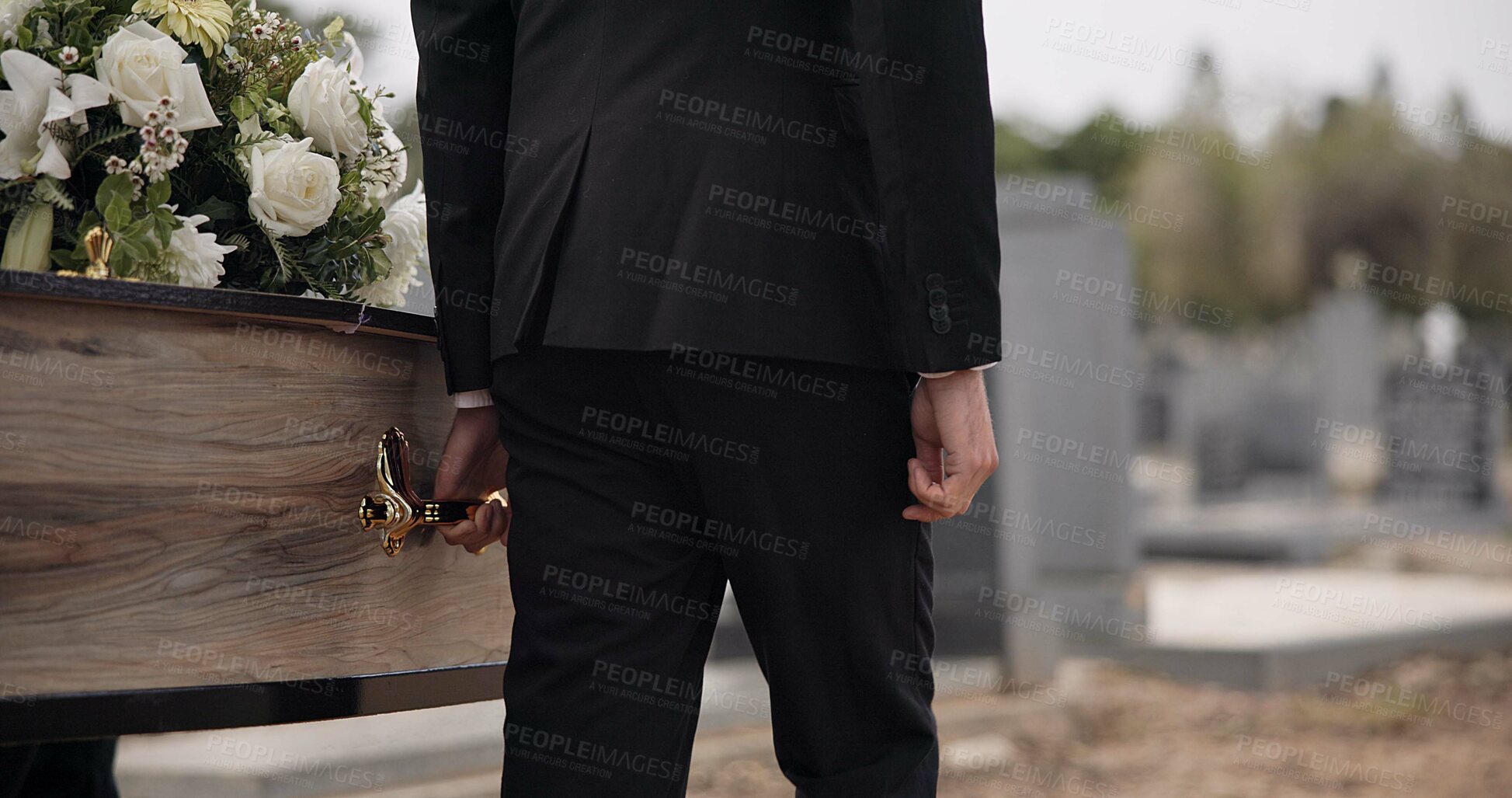 Buy stock photo Coffin, hands and man walking at funeral ceremony outdoor with pallbearers at tomb. Death, grief and person carrying casket at cemetery, graveyard or family service of people mourning at windy event