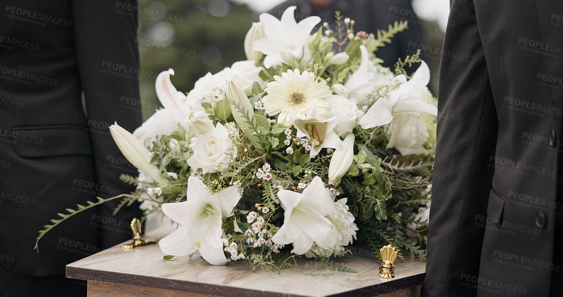 Buy stock photo Carrying coffin, flowers and people at funeral for service, mourning and at the graveyard. Closeup, support and group of family or friends with respect while holding casket during a ceremony together