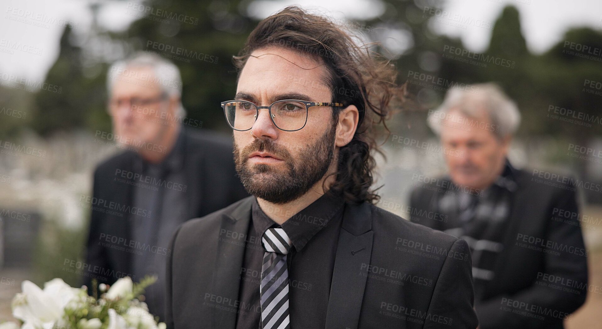 Buy stock photo Funeral, death and man carry coffin with family in grief, mourning and sad during church service for peace. Memorial, difficult and person with loss walking in the wind with casket in a ceremony