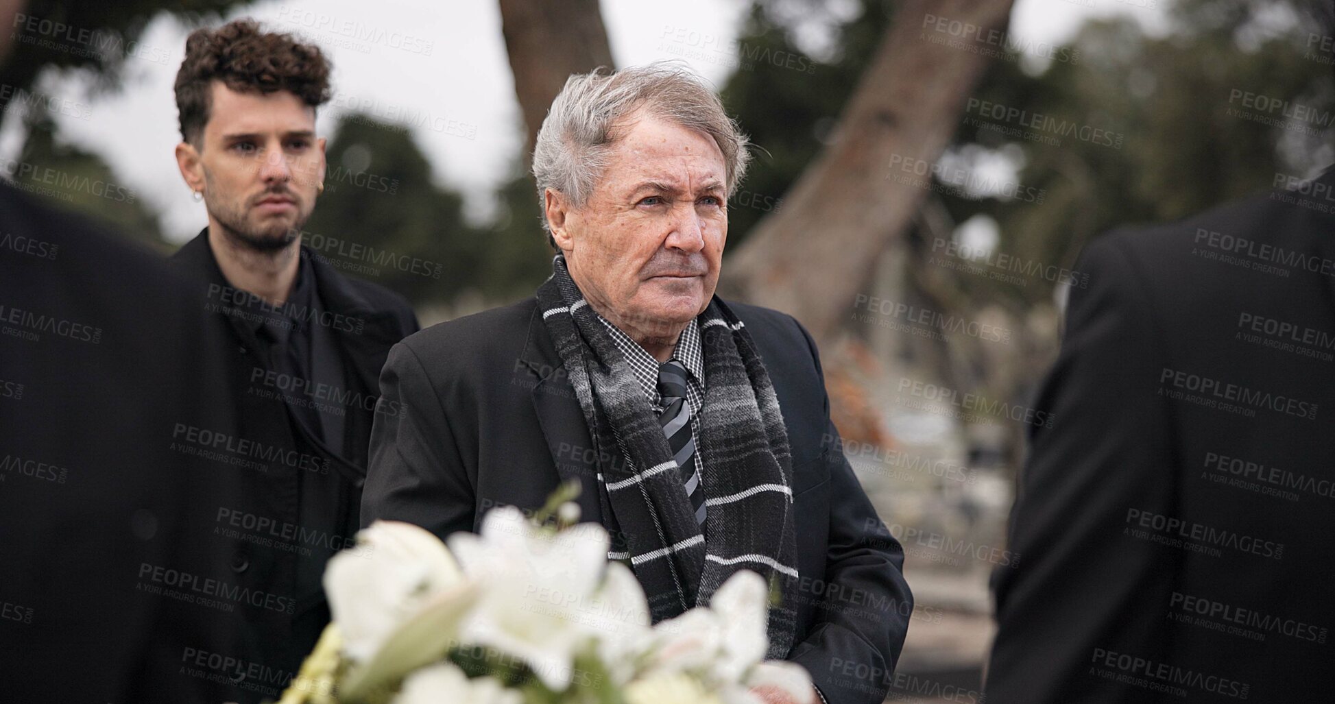 Buy stock photo Funeral, death and senior man carry coffin with family in grief, mourning and sad during church service for peace. Memorial, difficult and person with loss walking in the wind with casket at ceremony