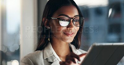 Tablet, overtime and happy woman in office with glasses, reflection with planning and website. Vision, smile and businesswoman typing email, late at night work and research on future ideas for agency