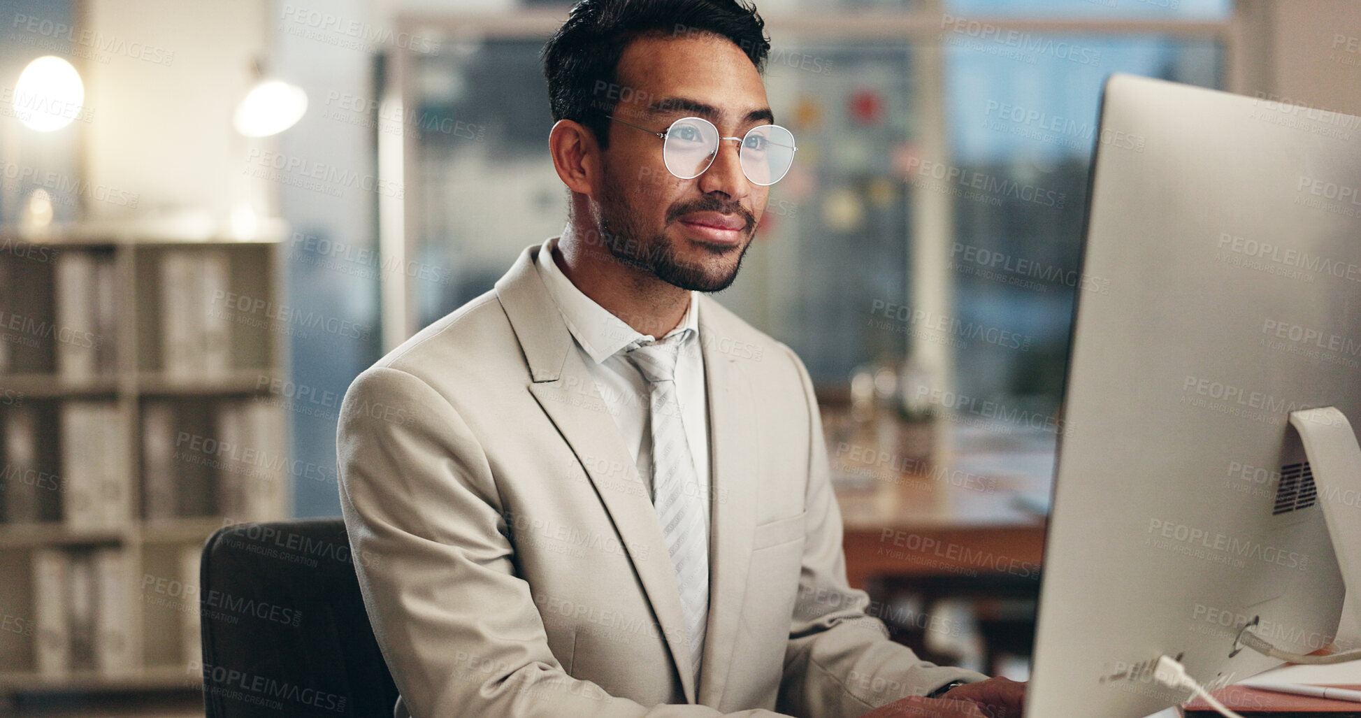 Buy stock photo Office computer, night and happy man typing email, communication and networking with business consultant. Smile, reading and professional person contact social media user, network admin or employee