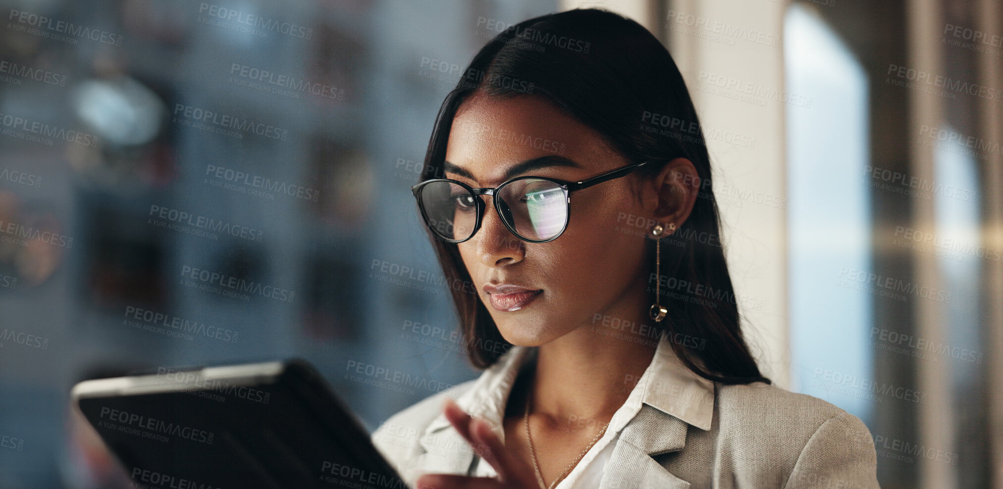 Buy stock photo Tablet, reflection and businesswoman with glasses, overtime in office with planning and scroll on social media. Vision, research and woman typing email, late at night work on future ideas for agency.