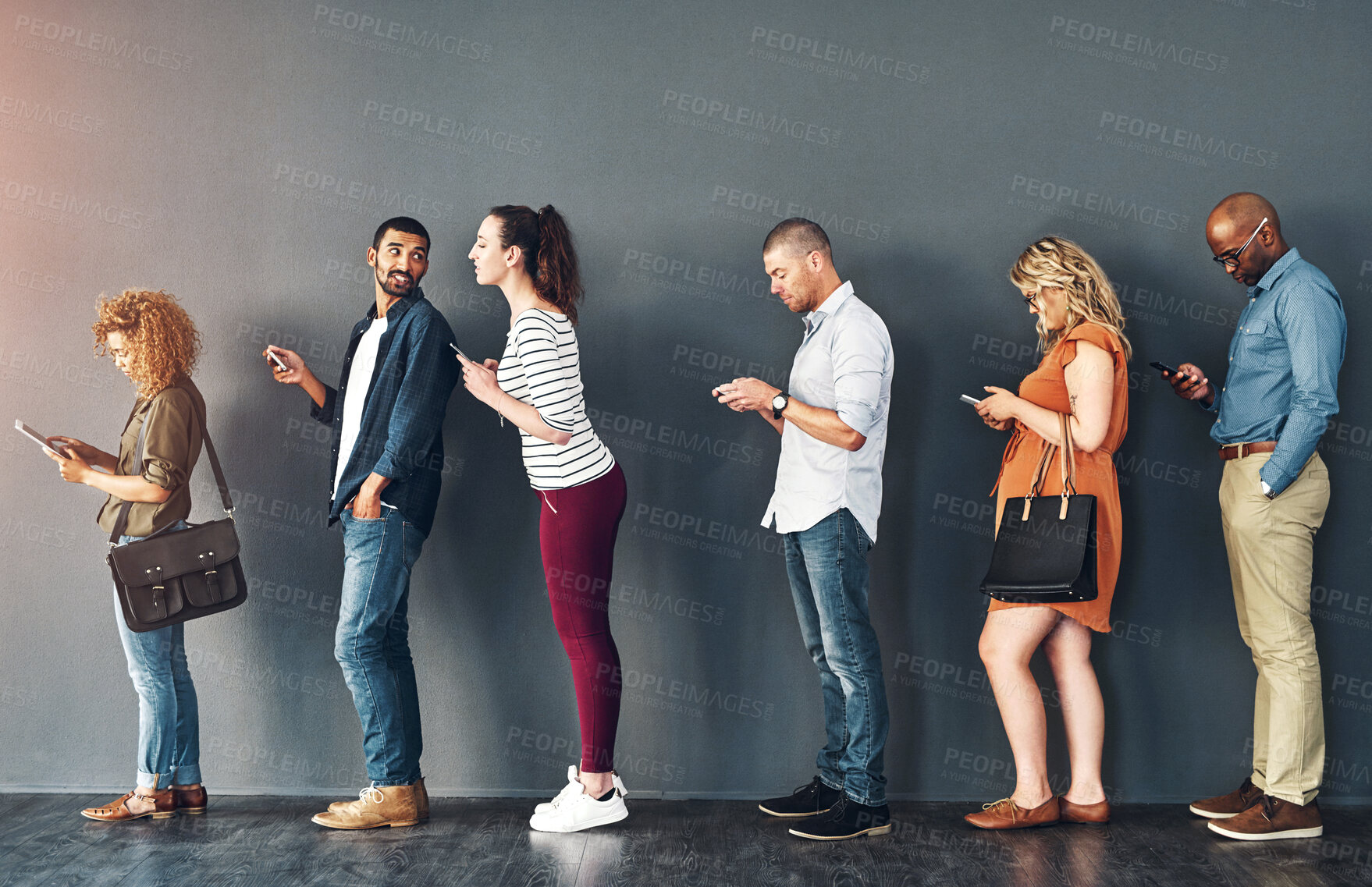 Buy stock photo Studio shot of people waiting in line against a grey background