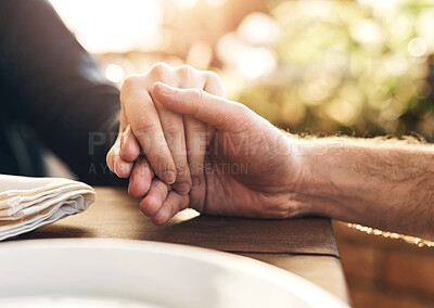 Buy stock photo Couple, holding hands and lunch with praying, love and trust  in marriage, hope and care at table outdoor. Man, woman and hand for hope, gratitude and prayer in Christian faith, spiritual or support
