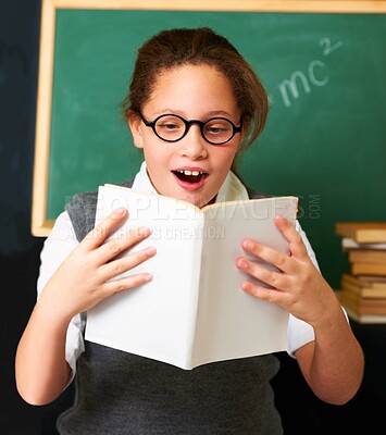 Buy stock photo Shock, reading and child student with book in classroom for knowledge, learning or education. Surprise, excited and young girl kid enjoy a story, fantasy or novel with glasses at school or academy.