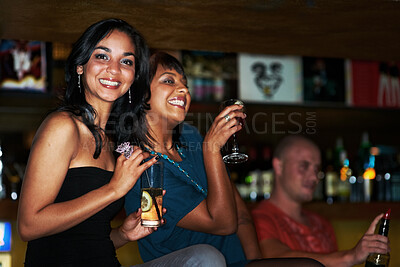Buy stock photo Two beautiful young girls out partying together and enjoying cocktails