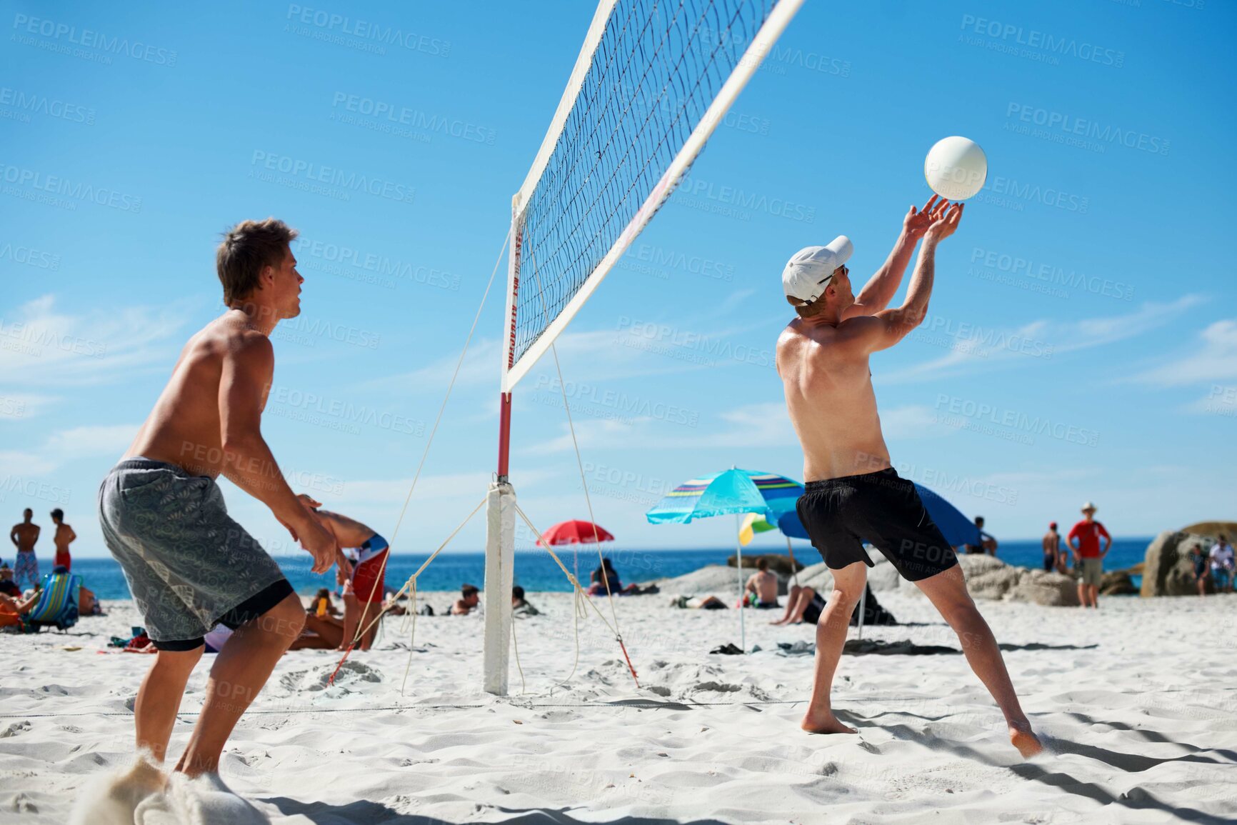 Buy stock photo Shot of a beach volleyball game on a sunny day