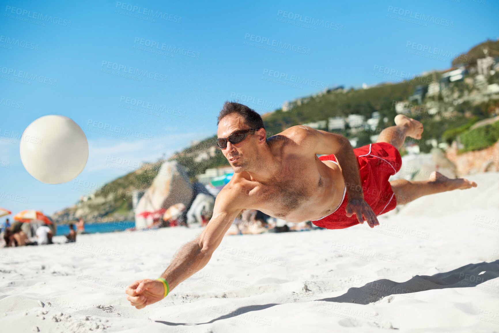 Buy stock photo Shot of a beach volleyball game on a sunny day