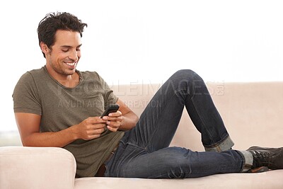 Buy stock photo Man, phone or smile on sofa with relax, communication or conversation for break in living room of home. Person, face or happy with smartphone or technology on couch in lounge for text message or chat