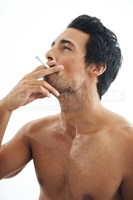 Buy stock photo Man, cigarette and smoking for addiction or drag of tobacco against a white studio background. Face of handsome or attractive male person, model or smoker addict in relax and enjoying stress relief