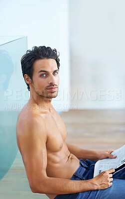 Buy stock photo Man, newspaper and shirtless or portrait for news, article or story on floor with relax and calm expression. Person, face and information update or break with tattoo, peace or routine in apartment