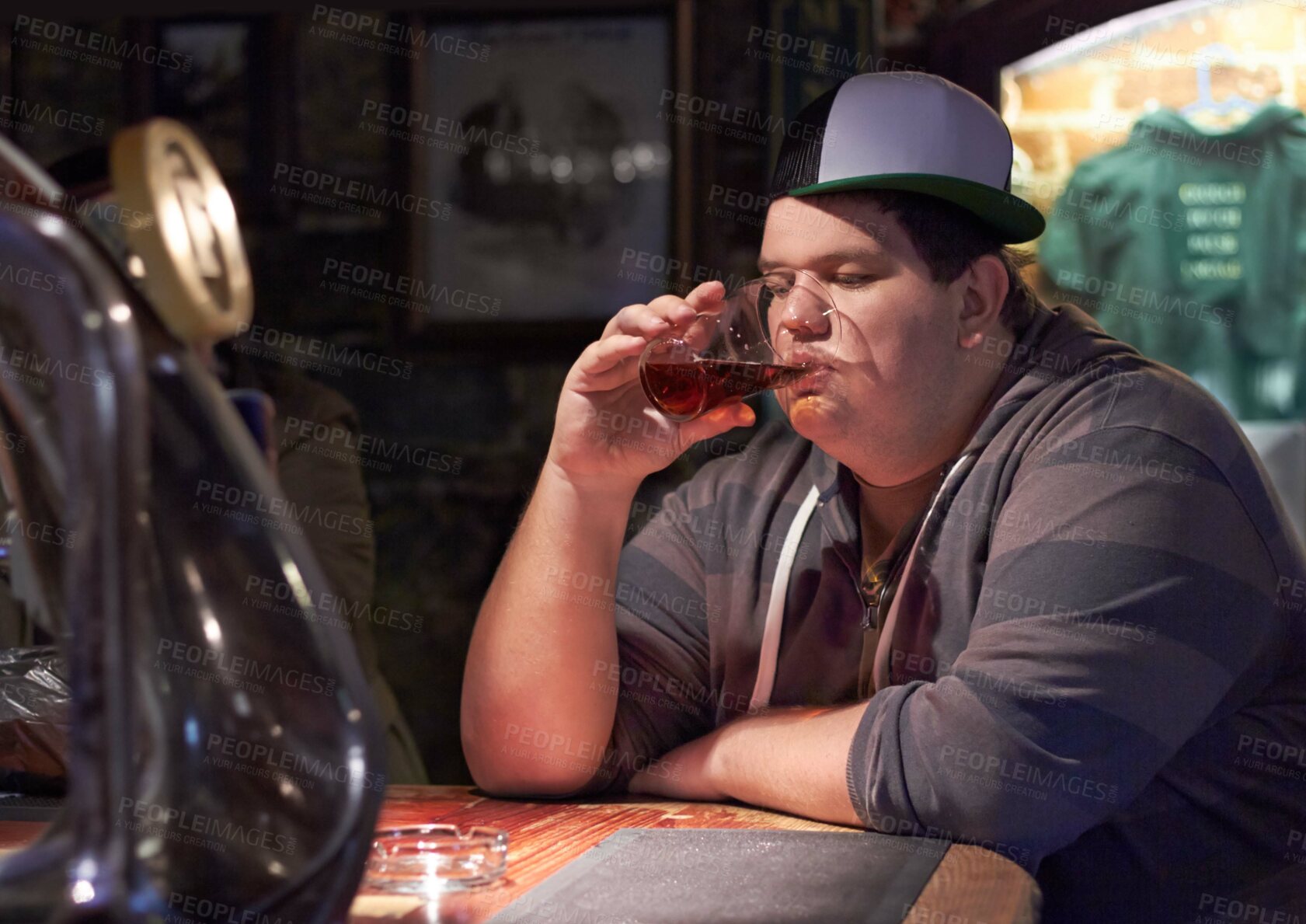 Buy stock photo Man in pub, beer and drinking alone, plus size and depressed with alcohol, mental health or life mistake. Body image crisis, angry or sad with alcoholic beverage in glass, frustration and loneliness