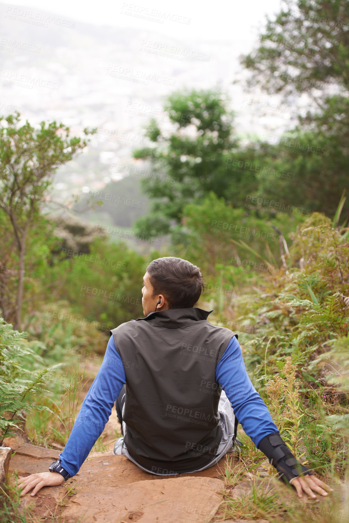 Buy stock photo Back, rock and man on break in nature training, cardio exercise and endurance workout for wellness. Sports person, fitness fatigue or tired athlete resting in forest or mountain trail outdoors