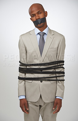 Buy stock photo Portrait, business and black man tied with rope, mouth covered with tape and compliance issue on white studio background. African person, employee or entrepreneur with control, policy or crisis