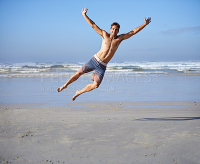 Buy stock photo Man, jumping and portrait for happiness at beach, outdoor fun and happy in summer on vacation. Young person, playing and leisure on holiday by sea, freedom and energy for travel adventure by waves