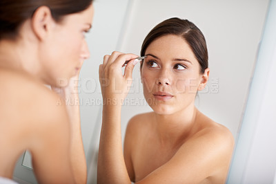 Buy stock photo Beauty, mirror reflection and woman with tweezers for eyebrow maintenance, hair removal or cosmetic treatment. Home bathroom, morning self care and person grooming with facial plucking tools