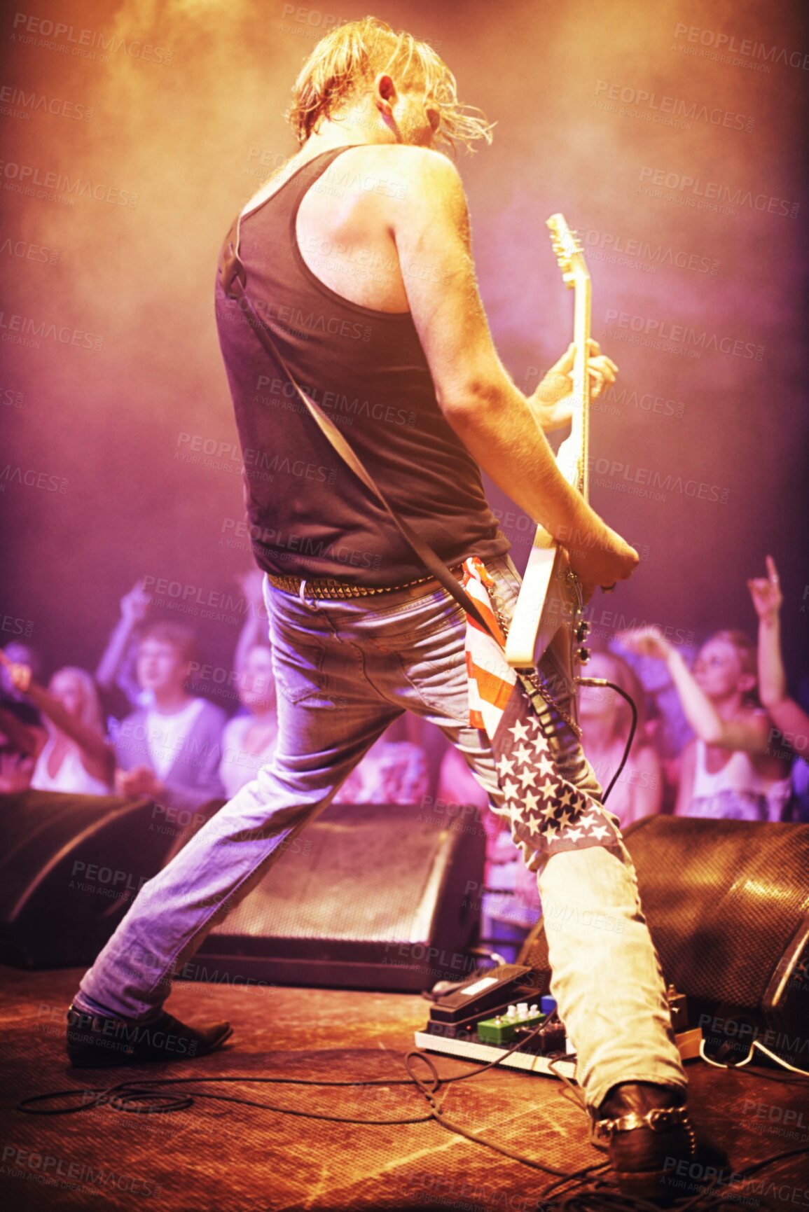 Buy stock photo Full length shot of a musician playing guitar for a crowd at a gig. This concert was created for the sole purpose of this photo shoot, featuring 300 models and 3 live bands. All people in this shoot are model released.