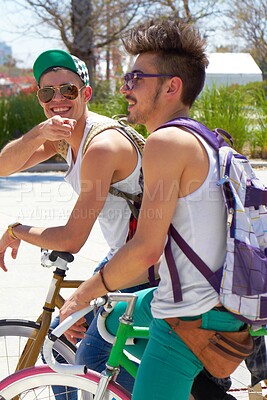 Buy stock photo Men, students and friends with back, bicycle and sustainable transportation on road in summer sunshine. Young gen z people, retro bike and outdoor together in street with travel on university campus