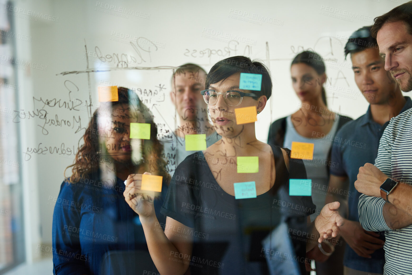 Buy stock photo Manager, leader or boss talking and planning in a workshop, seminar or presentation with sticky notes in a boardroom. Business woman discussing and brainstorming with her colleagues and coworkers