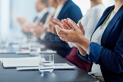 Buy stock photo Cropped shot of a group of unidentifiable businesspeople applauding while sitting in the boardroom