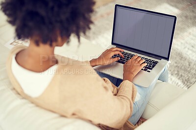 Buy stock photo Rearview shot of a young woman using a laptop at home