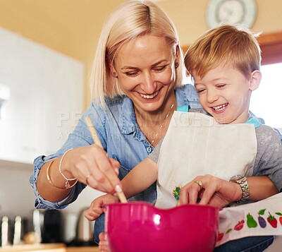 Buy stock photo Cropped shot of a mother and son baking together at home